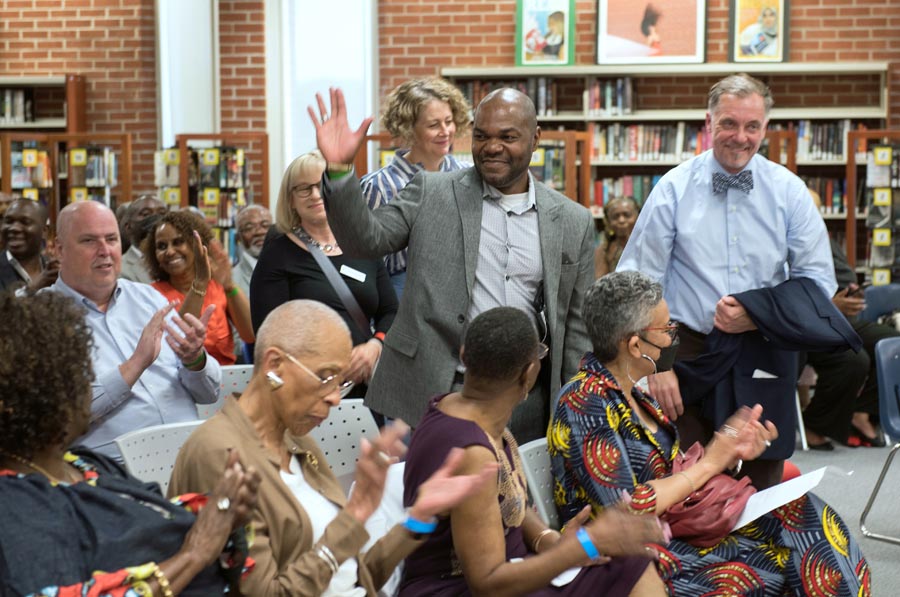 Trustee Moise waves to attendees. Open Gallery